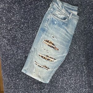 AMIRI Light Blue Distressed Jeans with Leopard Accents